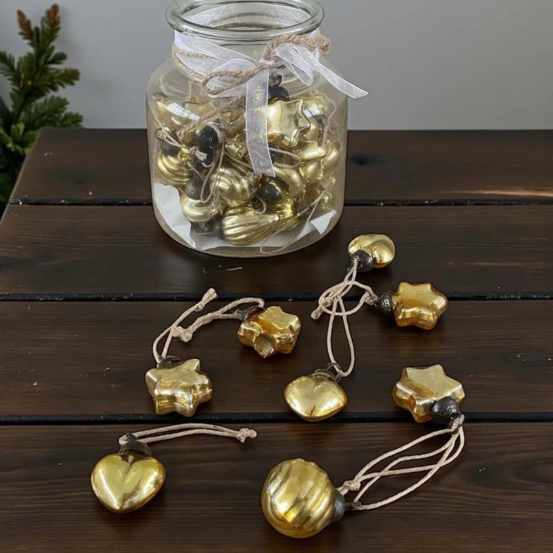 48 mini gold baubles in glass vase
