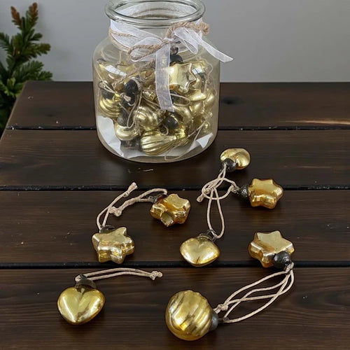48 mini gold baubles in glass vase