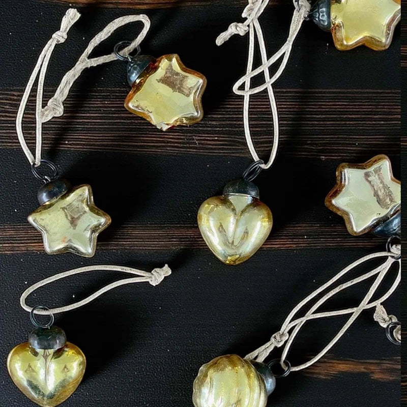 48 mini gold baubles in glass vase